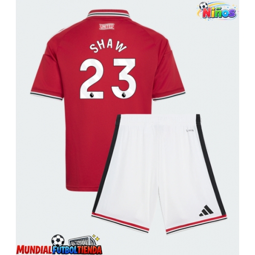 Camiseta Manchester United Luke Shaw #23 Primera Equipación Replica 2026-27 para niños mangas cortas (+ Pantalones cortos)